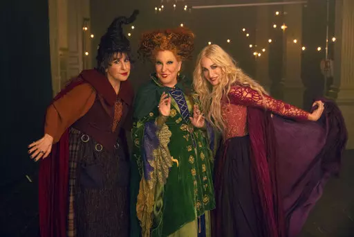This image released by Disney shows, from left, Kathy Najimy as Mary Sanderson, Bette Midler as Winifred Sanderson, and Sarah Jessica Parker as Sarah Sanderson in "Hocus Pocus 2." (Matt Kennedy/Disney via AP)