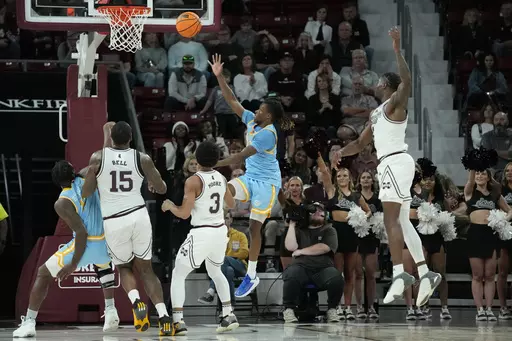 Southern University guard Brandon Davis, second from right, makes a banked shot to score in the final seconds against Mississippi State during the second half of an NCAA college basketball game, Sunday, Dec. 3, 2023, in Starkville, Miss. (AP Photo/Rogelio V. Solis)