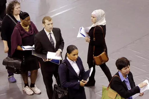 Job hunters line up for interviews at an employment fair sponsored by the New York State Department of Labor, Wednesday, Oct. 8, 2014 in the Brooklyn borough of New York. Just four months ago, city lawmakers overwhelmingly voted to require many ads for jobs in the nation's most populous city to include salary ranges, in the name of giving job applicants — particularly women and people of color — a better shot at fair pay. But on the cusp of implementing the measure, lawmakers voted Thursday 