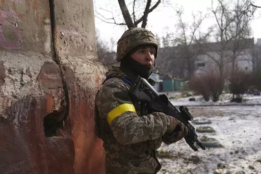 A Ukrainian serviceman guards his position in Mariupol, Ukraine, Saturday, March 12, 2022. Ukraine’s military says Russian forces have captured the eastern outskirts of the besieged city of Mariupol. In a Facebook update Saturday, the military said the capture of Mariupol and Severodonetsk in the east were a priority for Russian forces. Mariupol has been under siege for over a week, with no electricity, gas or water. (AP Photo/Evgeniy Maloletka)