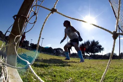The goalkeeper guards the net as girls take part in the first day of tryouts for the Fort Walton Beach High School girls' soccer team in Fort Walton Beach, Fla., on Oct. 10, 2012. Facing blowback, the leader of Florida’s high school sports association is backing away from using a permission form that requires female athletes to disclose their menstrual history. The association's board is meeting Thursday, Feb. 9, 2023, to vote on whether to adopt a new recommendation that most personal informa