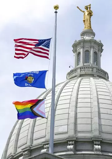 In this Wednesday, June 1, 2022, photo, a Rainbow Pride flag is raised at the Capitol in Madison, Wis. A Wisconsin school board has voted in favor of a policy that prohibits teachers and staff from displaying gay pride flags and other items that district officials consider political in nature. (Mark Hoffman/Milwaukee Journal-Sentinel via AP, File)
