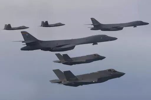 In this photo provided by South Korean Defense Ministry, U.S. Air Force B-1B bombers, center, F-22 fighter jets and South Korean Air Force F-35 fighter jets, bottom, fly over South Korea Peninsula during a joint air drill in South Korea, on Jan. 1, 2023. South Korean and U.S. militaries will hold a table-top exercise at the Pentagon next week to hone their joint response to a potential use of nuclear weapons by North Korea, Seoul officials said Friday, Feb. 17, 2023. (South Korean Defense Minist