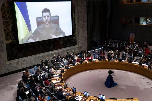 Ukrainian President Volodymyr Zelenskyy speaks via remote feed during a meeting of the UN Security Council, Tuesday, April 5, 2022, at United Nations headquarters.  Zelenskyy will address the U.N. Security Council for the first time Tuesday at a meeting that is certain to focus on what appear to be widespread deliberate killings of civilians by Russian troops. (AP Photo/John Minchillo)