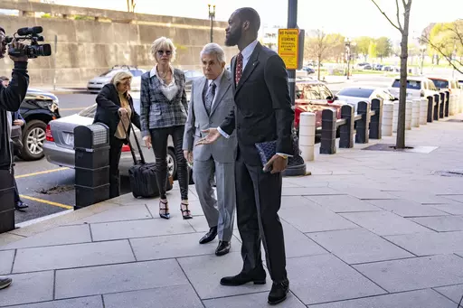 Prakazrel "Pras" Michel, a member of the 1990s hip-hop group the Fugees, accompanied by defense lawyer David Kenner, center left, arrives at federal court for his trial in an alleged campaign finance conspiracy, Monday, April 3, 2023, in Washington. (AP Photo/Andrew Harnik)