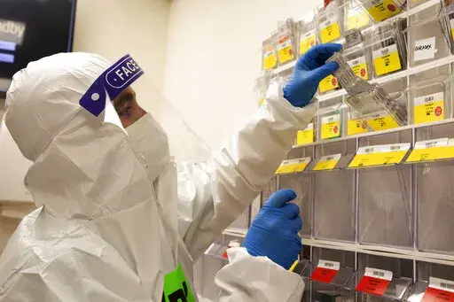 A medical professional pulls patient medication in the coronavirus ward at the Shaare Zedek Medical Center in Jerusalem, Tuesday, Aug. 31, 2021. (AP Photo/Maya Alleruzzo)