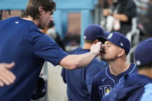 Tampa Bay Rays' Ryan Pepiot, left, adjusts the mustache of starting pitcher Tyler Alexander before a baseball game against the Los Angeles Dodgers in Los Angeles, Friday, Aug. 23, 2024. (AP Photo/Ashley Landis, File)