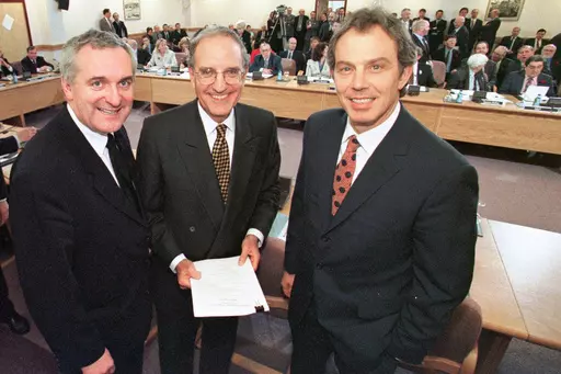 FILE- From left, Irish Prime Minister Bertie Ahern, U.S. Sen. George Mitchell, and British Prime Minister Tony Blair, pose together after signing the Good Friday Agreement, in, Belfast, Northern Ireland, Friday, April 10, 1998. Former U.S. President Bill Clinton and past leaders of the U.K. and Ireland are gathering in Belfast on Monday, April 17, 2023, 25 years after their charm, clout and determination helped Northern Ireland strike a historic peace accord. (Dan Chung/Pool Photo via AP, File)