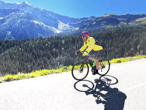 Steve Wartenberg cycles on the D4 road to the summit of the Col de la Colombiere near the village of Le Reposoir in the French Alps on Sept. 20, 2022. (Mike Booth via AP)