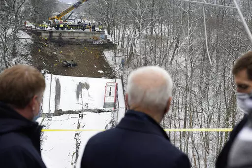 President Joe Biden visits the site where the Fern Hollow Bridge collapsed Friday, Jan. 28, 2022, in Pittsburgh's East End. (AP Photo/Andrew Harnik)