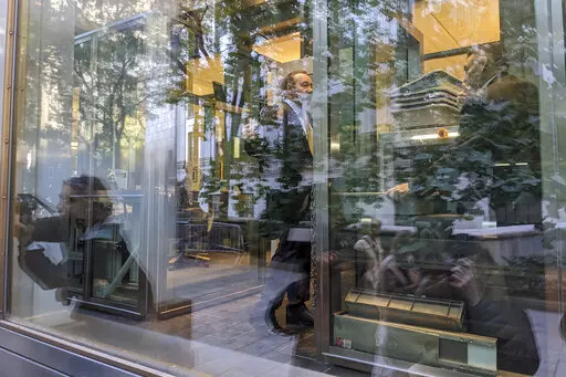 Video journalists and photographers are reflected in the glass as they cover the arrival of actor Kevin Spacey for a civil case at a federal courthouse in lower Manhattan in New York on Thursday, Oct. 20, 2022. (AP Photo/Ted Shaffrey)