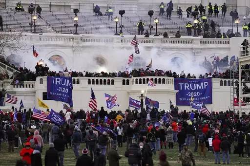 People loyal to President Donald Trump storm the U.S. Capitol on Jan. 6, 2021, in Washington. Federal authorities say a Southern California man who assaulted police with pepper spray during the storming of the U.S. Capitol was sentenced to 4 1/2 years in prison. The U.S. Department of Justice said in a statement Friday, April 28, 2023, that Jeffrey Scott Brown of Santa Ana, Calif., received a sentence of 54 months. (AP Photo/John Minchillo, File)