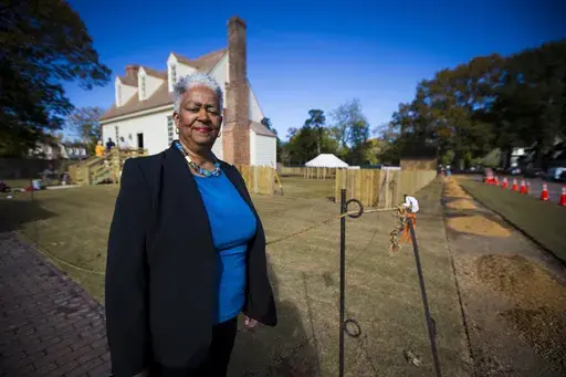 Janice Canaday, Colonial Williamsburg Foundations African American community engagement manager, stands outside near the Williamsburg Bray School on Wednesday, Oct 30, 2024 in Williamsburg, Va. (AP Photo/John C. Clark)