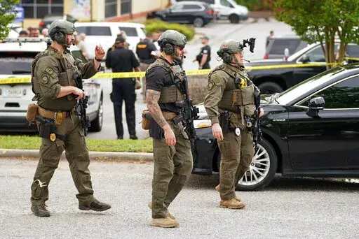Authorities stage outside Columbiana Centre mall in Columbia, S.C., following a shooting, Saturday, April 16, 2022. (AP Photo/Sean Rayford)