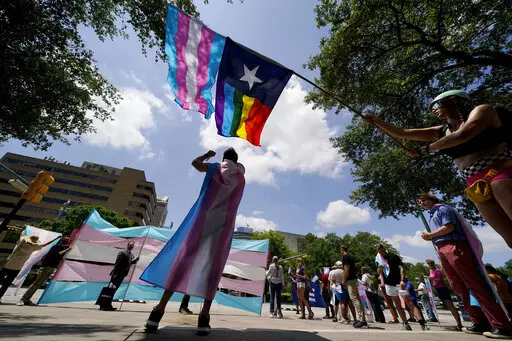 Demonstrators gather on the steps to the State Capitol to speak against transgender-related legislation bills being considered in the Texas Senate and Texas House, Thursday, May 20, 2021 in Austin, Texas. A Texas judge on Friday, March 11, 2022 blocked the state from investigating as child abuse gender confirming care for transgender youth. District Judge Amy Clark Meachum issued a temporary injunction preventing the state from enforcing Republican Gov. Greg Abbott’s directive to compel the De