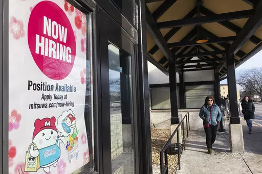 A hiring sign is displayed at a grocery store in Arlington Heights, Ill., Tuesday, Dec. 27, 2022. On Thursday, the Labor Department reports on the number of people who applied for unemployment benefits last week. (AP Photo/Nam Y. Huh, File)