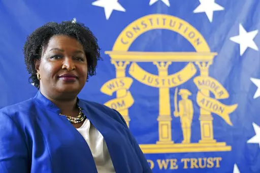 Democratic candidate for Georgia governor Stacey Abrams poses for a portrait in front of the State Seal of Georgia on Aug. 8, 2022, in Decatur, Ga. Abrams founded Fair Fight Action, a group focused on fair elections, that filed a wide-ranging federal lawsuit alleging “gross mismanagement” of Georgia’s elections. That lawsuit sputtered out Friday, Sept. 30, with Fair Fight losing its last remaining arguments, more than a year after the judge had tossed most earlier claims. (AP Photo/John Ba