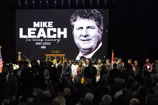 Current football players enter the memorial service for their late Mississippi State football coach Mike Leach, at Humphrey Coliseum on the university's campus in Starkville, Miss., Tuesday, Dec. 20, 2022. Leach died, Dec. 12, 2022, from complications related to a heart condition at 61. He was in his third year as head coach. (AP Photo/Rogelio V. Solis)
