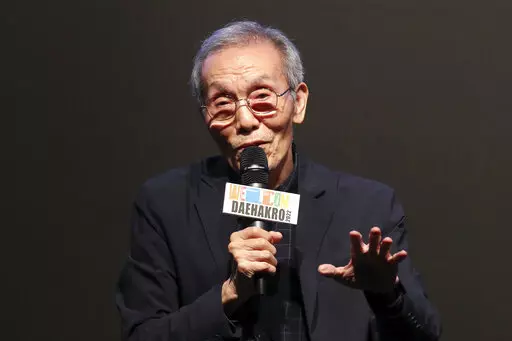 South Korean actor Oh Young-soo speaks during a press conference at the Welcome Daehakro Festival 2022 in Seoul, South Korea, Sept. 21, 2022. Award-winning “Squid Game” actor Oh will stand trial on charges of indecent assault after a woman accused him of inappropriately touching her in 2017, a South Korean court said. (Park Jin-hee/Newsis via AP)