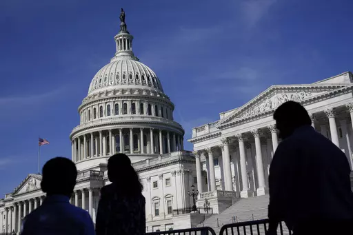 People walk outside the U.S Capitol building in Washington, June 9, 2022. President Joe Biden goes into Thursday's State of the Union address with an expanded plan to raise corporate taxes. He would use the proceeds to trim budget deficits and cut taxes for the middle class.(AP Photo/Patrick Semansky, File)