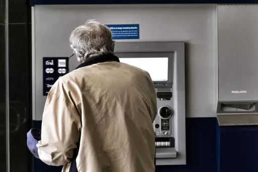 A customer makes a transaction at an automatic teller machine in Los Angeles on March 27, 2023. The cost to overdraw a bank account could drop to as little as $3 under a proposal announced by the White House, the latest move by the Biden administration to combat fees it says pose an unnecessary burden on American consumers, particularly those living paycheck to paycheck. (AP Photo/Richard Vogel, File)