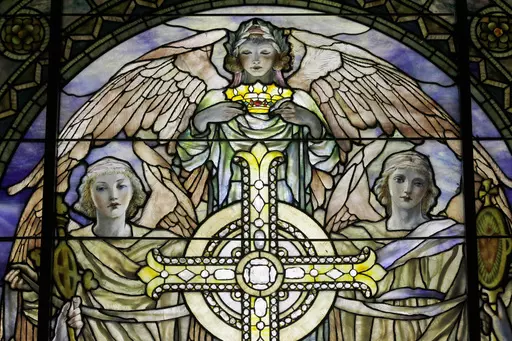 A detail of "The Righteous Shall Receive a Crown of Glory," Brainard Memorial Window for Methodist Church, Waterville, New York, ca. 1901 is photographed while on display at the "Louis C. Tiffany and the Art of Devotion" exhibit at the Museum of Biblical Art in New York on Thursday, Oct. 25 2012. About 7 in 10 U.S. adults say they believe in angels, according to a new poll released on Saturday, July 29, 2023, by The Associated Press-NORC Center for Public Affairs Research. (AP Photo/Mary Altaffe