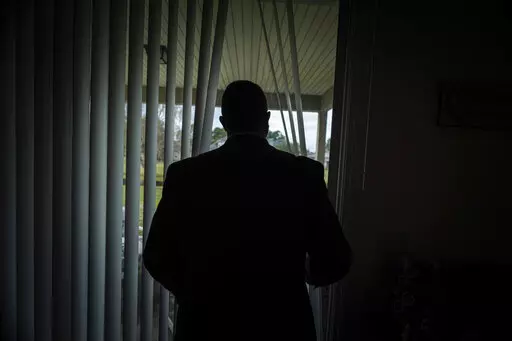 Joseph Moore looks out of a window at his home in Jacksonville, Fla., on Tuesday, Dec. 7, 2021. Moore worked for nearly 10 years as an undercover informant for the FBI, infiltrating the Ku Klux Klan in Florida, foiling at least two murder plots, according to investigators, and investigating ties between law enforcement and the white supremacist organization. “From where I sat, with the intelligence laid out, I can tell you that none of these agencies have any control over any of it. It is more