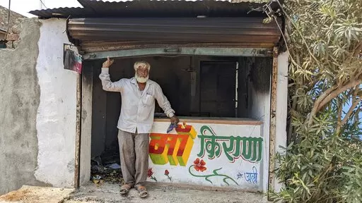 Nawab Khan stands by the entrance of his shop  vandalized by a mob on April 10 in Khargone, in the central Indian state of Madhya Pradesh, Tuesday, April 12, 2022. On April 10, a Hindu festival marking the birth anniversary of Lord Ram turned violent in Khargone after Hindu mobs brandishing swords and sticks marched past Muslim neighborhoods and mosques. Videos showed hundreds of them dancing and cheering in unison to songs blared from loudspeakers that included calls for violence against Muslim