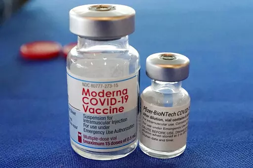 This Sept. 21, 2021 file photo shows vials of the Pfizer and Moderna COVID-19 vaccines in Jackson, Miss. Moderna is suing its main competitors Pfizer and the German drugmaker BioNTech, accusing the rivals of copying Moderna’s technology in order to make their own vaccine. Moderna said Friday, Aug. 26, 2022, that Pfizer and BioNTech’s vaccine Comirnaty infringes on patents Moderna filed several years ago protecting the technology behind its preventive shot, Spikevax.  (AP Photo/Rogelio V. Sol