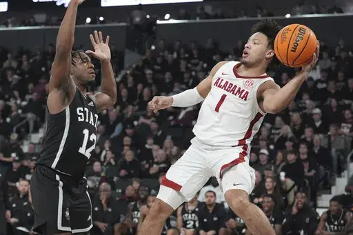 Alabama guard Mark Sears (1) attempts to pass the ball by Mississippi State guard Josh Hubbard (12) during the first half of an NCAA college basketball game, Wednesday, Jan. 29, 2025, in Starkville, Miss. (AP Photo/Rogelio V. Solis)