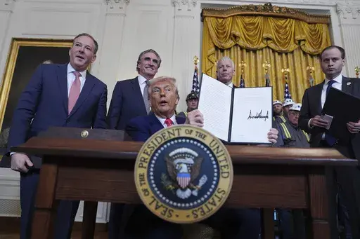 President Donald Trump holds a signed an executive order during an event in the East Room of the White House, Tuesday, April 8, 2025, in Washington, as from left Environmental Protection Agency director Lee Zeldin, Interior Secretary Doug Burgum, Energy Secretary Chris Wright and White House staff secretary Will Scharf watch. (AP Photo/Evan Vucci)