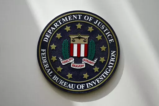 The FBI seal is pictured in Omaha, Neb., Aug. 10, 2022. The FBI is searching for a Florida woman who was supposed to stand trial Monday, March 6, 2023, on charges stemming from the Jan. 6, 2021, Capitol attack as well as another riot defendant who has gone missing. An FBI agent said Monday that a federal judge in Washington issued bench warrants for the arrest of Olivia Pollock and Joseph Hutchinson III last week after the court was notified that they had tampered with or removed the ankle monit