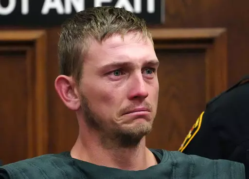 Chad Doerman sheds a tear as he stands just inside the Clermont County Municipal courtroom for his bond hearing, Friday, June 16, 2023 in Batavia, Ohio. Doerman allegedly shot and killed his three young sons and wounded their mother at their Ohio home. (Liz Dufour/The Cincinnati Enquirer via AP)