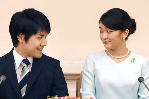 Japan's Princess Mako and her fiance Kei Komuro look at each other during a press conference at Akasaka East Residence in Tokyo on Sept. 3, 2017.  Komuro has passed the New York bar exam, defying detractors back home who had criticized their romance. (AP Photo/Shizuo Kambayashi, Pool, File)