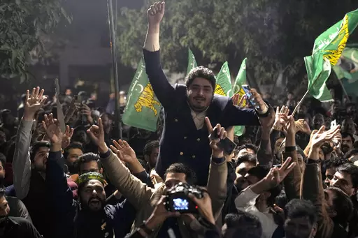 Supporters of Former Prime Minister Nawaz Sharif' party 'Pakistan Muslim League-N' dance to celebrate their party victory in the initial results of the country's parliamentary election, in Lahore, Pakistan, Friday, Feb. 9, 2024. (AP Photo/K.M. Chaudary)