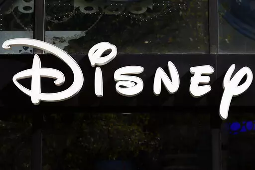 This Sept. 20, 2017, file photo shows a sign at the Disney store on the Champs Elysees Avenue in Paris, France.  The Supreme Court’s decision to end the nation’s constitutional protections for abortion has catapulted businesses of all types into the most divisive corner of politics. A rash of iconic names including The Walt Disney Company, Facebook parent Meta, and Goldman Sachs announced they would pay for travel expenses for those who want the procedure but can't get it in the states they 