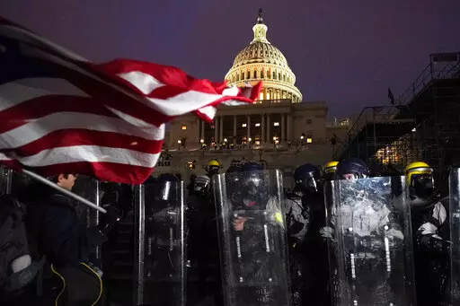 Police stand guard after a day of riots at the U.S. Capitol in Washington on Wednesday, Jan. 6, 2021. On Friday, Oct. 21, 2022, a Tennessee business owner who scaled a wall outside the U.S. Capitol was sentenced to four years in prison after he was convicted of five charges connected to the raid on Jan. 6, 2021, federal prosecutors said. (AP Photo/Julio Cortez, File)
