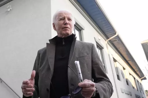 President Joe Biden speaks with reporters as he leaves St. Edmund Roman Catholic Church in Rehoboth Beach, Del., Saturday, Feb. 17, 2024, after attending a Mass. On Friday, Feb. 23, The Associated Press reported on stories circulating online incorrectly claiming Biden issued Executive Order 9066, which provides people who enter the U.S. illegally with a $5,000 Visa gift card. (AP Photo/Alex Brandon, File)