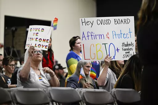 Parents, students, and staff of Chino Valley Unified School District hold up signs in favor of protecting LGBTQ+ policies at Don Antonio Lugo High School, on Thursday, June 15, 2023. California's attorney general has sued a Southern California school district over its new policy that requires schools to notify parents if their children change their gender identification or pronouns. Attorney General Rob Bonta announced the suit Monday, Aug. 28, against Chino Valley Unified School District. (Phot