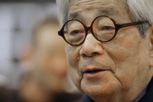 Japanese Nobel Prize winning author Kenzaburo Oe poses during the inauguration of the 32nd Paris Book Fair, which focused on Japanese writers, March 15, 2012. Japanese publisher Kodansha Ltd. said Monday, March 13, 2023 that Nobel literature laureate Kenzaburo Oe died of old age. Oe's darkly poetic novels were built from a childhood during Japan’s postwar occupation and parenthood with a disabled son. (AP Photo/Jacques Brinon, File)