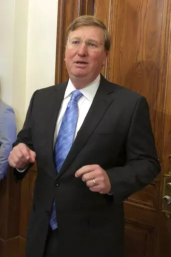 Mississippi Gov. Tate Reeves speaks Thursday, March 24, 2022, during a news conference outside his Capitol office in Jackson, Miss. The Republican says he wants legislators to phase out the state income tax. (AP Photo/Emily Wagster Pettus)