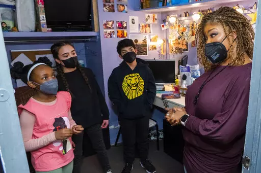 Sydney Elise Russell, from left, Alayna Martus and Vince Ermita share Black History Month facts with Bonita J. Hamilton backstage at the Minskoff Theatre before a performance of Broadway's "The Lion King" on Friday, Feb. 18, 2022, in New York. (Photo by Charles Sykes/Invision/AP)