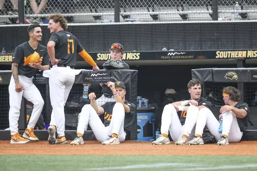 Tennessee players relax during a lightning delay during an NCAA college baseball tournament super regional game against Southern Mississippi in Hattiesburg, Miss., Saturday, June 10, 2023. (James Pugh/impact601.com via AP)