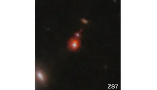 This image released by NASA shows the ZS7 galaxy system, revealing the ionized hydrogen emission in orange and the doubly ionized oxygen emission in dark red. (ESA/Webb, NASA via AP)
