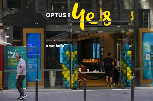 A customer waits for service at a Optus phone store in Sydney, Australia, Thursday, Oct. 7, 2021. The Australian government said on Monday, Sept. 26, 2022, it was considering tougher cybersecurity rules for telecommunications companies after Optus, the nation’s second-largest wireless carrier, reported personal data of 9.8 million customers had been breached. (AP Photo/Mark Baker, File)