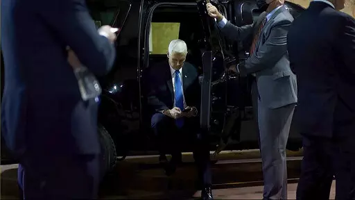 In this image from video released by the House Select Committee, Vice President Mike Pence looks at a phone from his secure evacuation location on Jan. 6 that is displayed as House select committee investigating the Jan. 6 attack on the U.S. Capitol holds a hearing Thursday, June 16, 2022, on Capitol Hill in Washington. (House Select Committee via AP)