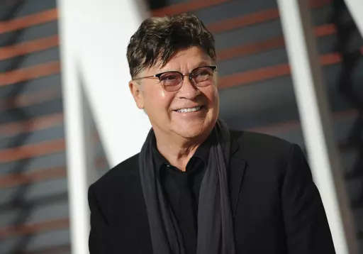 Musician Robbie Robertson arrives at the Vanity Fair Oscar Party on Sunday, Feb. 22, 2015, in Beverly Hills, Calif. Robertson, the lead guitarist and songwriter for The Band, whose classics include “The Weight,” “Up on Cripple Creek” and “The Night They Drove Old Dixie Down,” has died at 80, according to a statement from his manager. (Photo by Evan Agostini/Invision/AP, File)