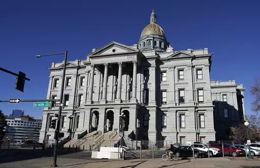 A lone cyclist passes by Colorado's State Capitol building, Friday, Jan. 15, 2021, in Denver. Colorado passed a law Thursday, May 25, 2023, requiring that patients give informed consent for medical students to perform pelvic exams on them while they are unconscious. (AP Photo/David Zalubowski, File)