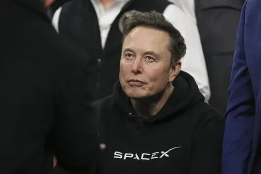 Elon Musk attends the finals at the NCAA wrestling championship, Saturday, March 22, 2025, in Philadelphia. (AP Photo/Matt Rourke)