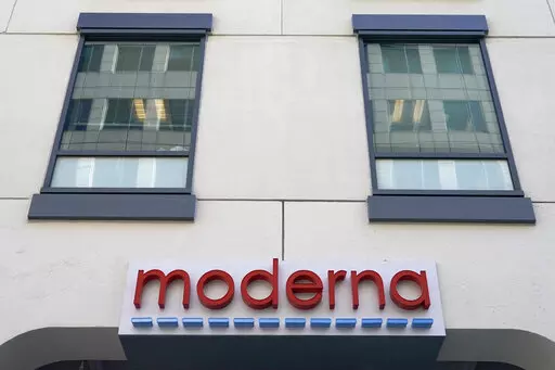 In this Dec. 15, 2020, file photo, a sign for Moderna, Inc. hangs on its headquarters in Cambridge, Mass.  Moderna's experimental COVID-19 vaccine that combines its original shot with protection against the omicron variant appears to work, the company announced Wednesday, June 8, 2022.  COVID-19 vaccine makers are studying updated boosters that might be offered in the fall to better protect people against future coronavirus surges.(AP Photo/Elise Amendola, File)
